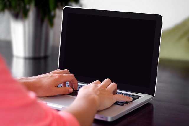 Hands Typing on Notebook Computer